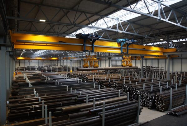 factory crane lifting steel pipes