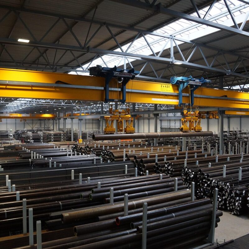 factory crane lifting steel pipes
