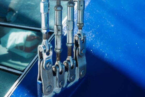 Industrial rigging shackles and lifting hardware used for heavy equipment moving in manufacturing facility