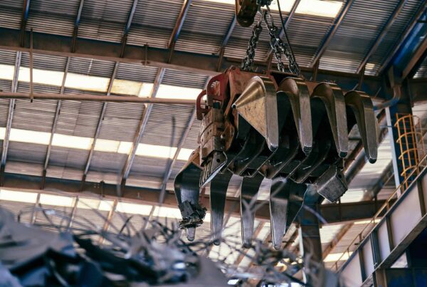 Industrial crane hook and chain suspended inside manufacturing facility for heavy equipment rigging in Atlanta