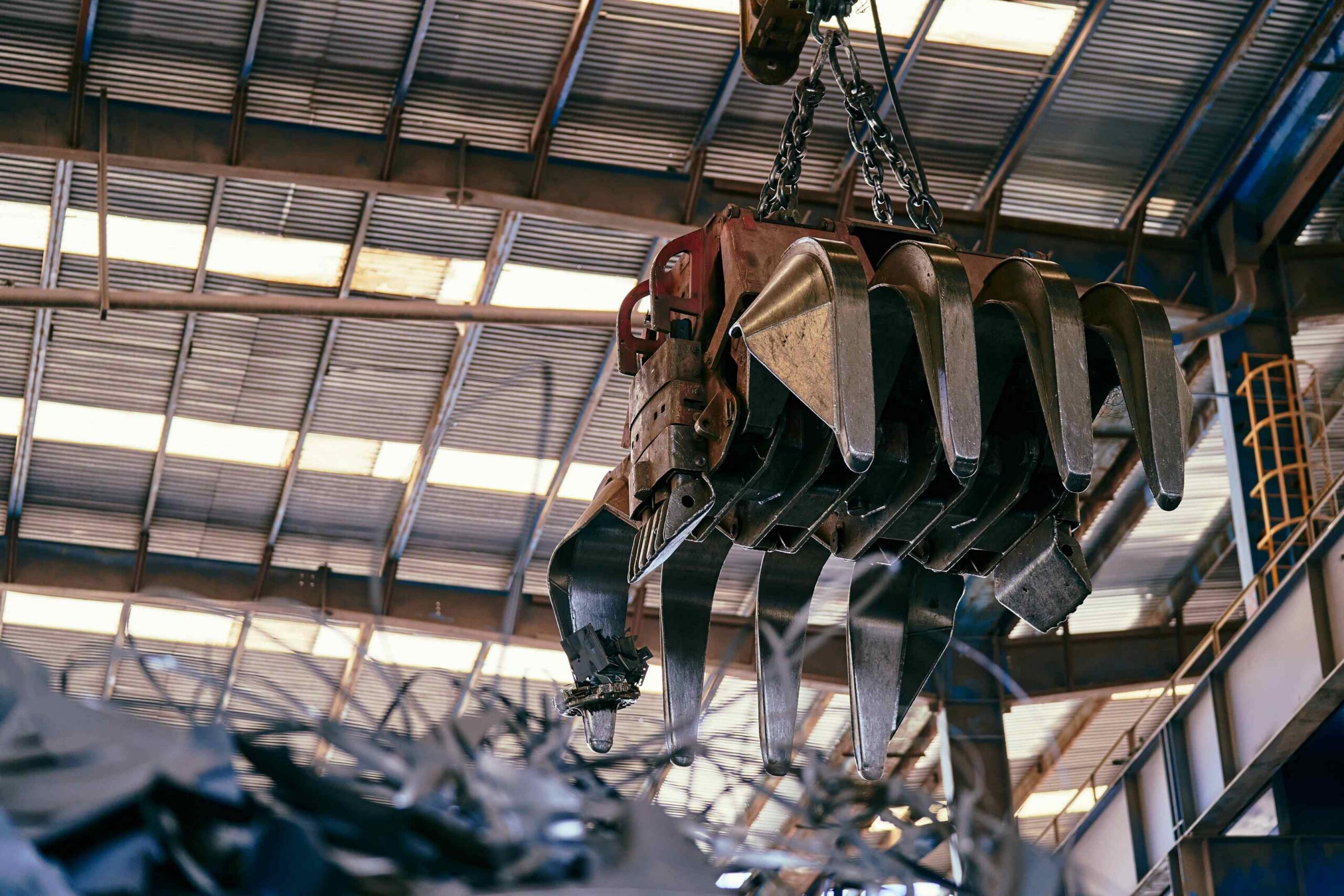 Industrial crane hook and chain suspended inside manufacturing facility for heavy equipment rigging in Atlanta