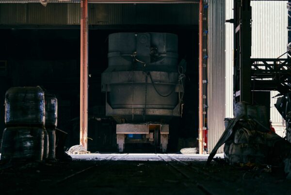 Large industrial machine being transported through facility bay doors during plant relocation in Atlanta