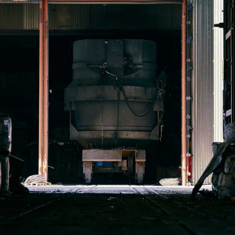 Large industrial machine being transported through facility bay doors during plant relocation in Atlanta