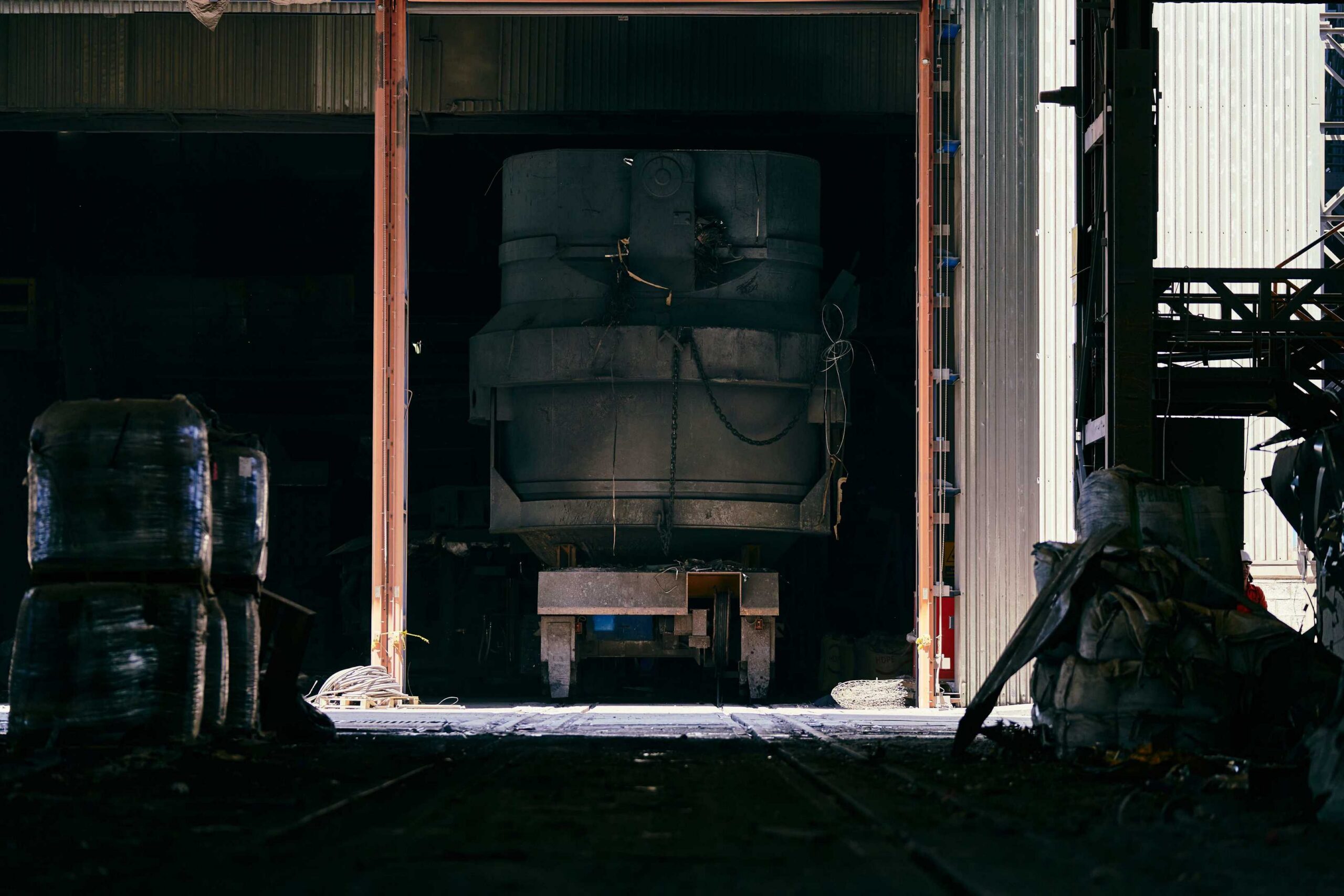 Large industrial machine being transported through facility bay doors during plant relocation in Atlanta