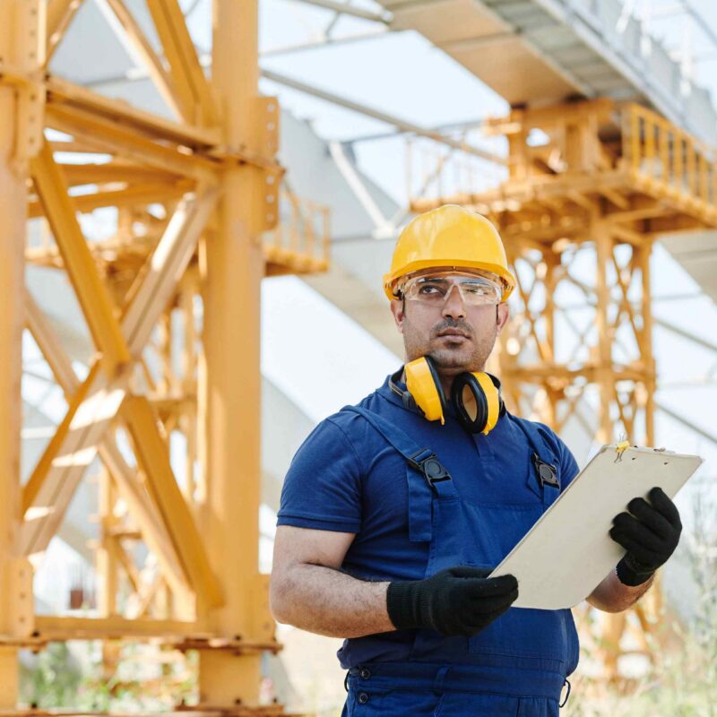 Certified rigger reviewing safety documentation at an industrial job site